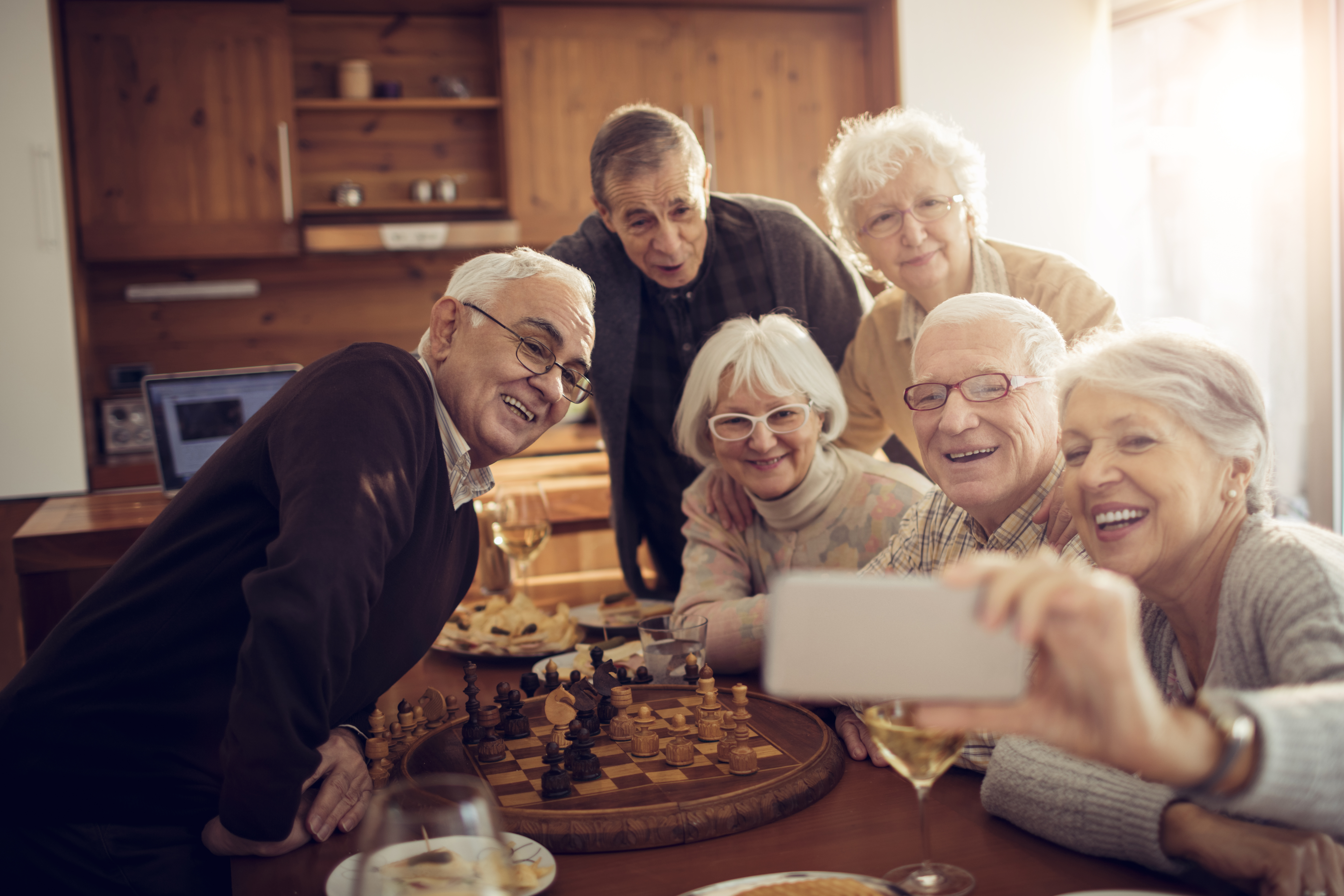 group of older adults smiling together for a selfie